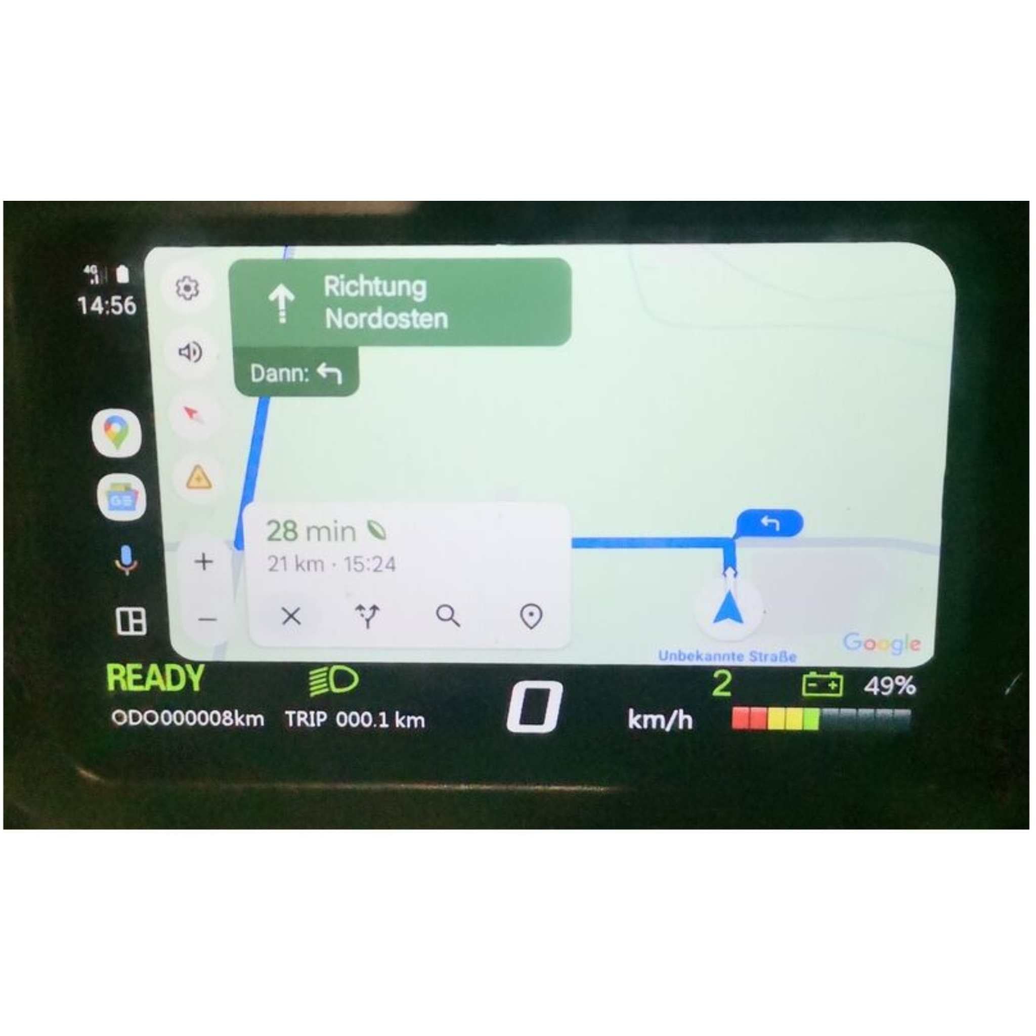 Das Dashboard des Trinity Jupiter GT 300 E-Scooters zeigt Google Maps für eine 28-minütige Route, die aktuelle Geschwindigkeit, den Batteriestand von 49 %, den Kilometerzähler, die Zeit (14:56) und eine Reichweite von bis zu 300 km.