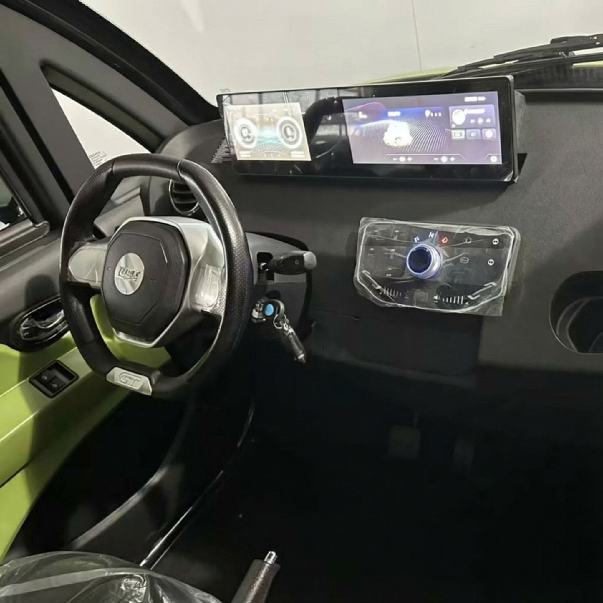 Das Bild zeigt den Innenraum des City Twister Luqi EV300 Pro Kabinenroller (Facelift Modell 2026), ein kompaktes Kleinstfahrzeug mit modernem, minimalistischem Design, digitalen Bildschirmen auf dem Armaturenbrett, Schalthebel und Klimatisierung für den täglichen Komfort bei 45 km/h.